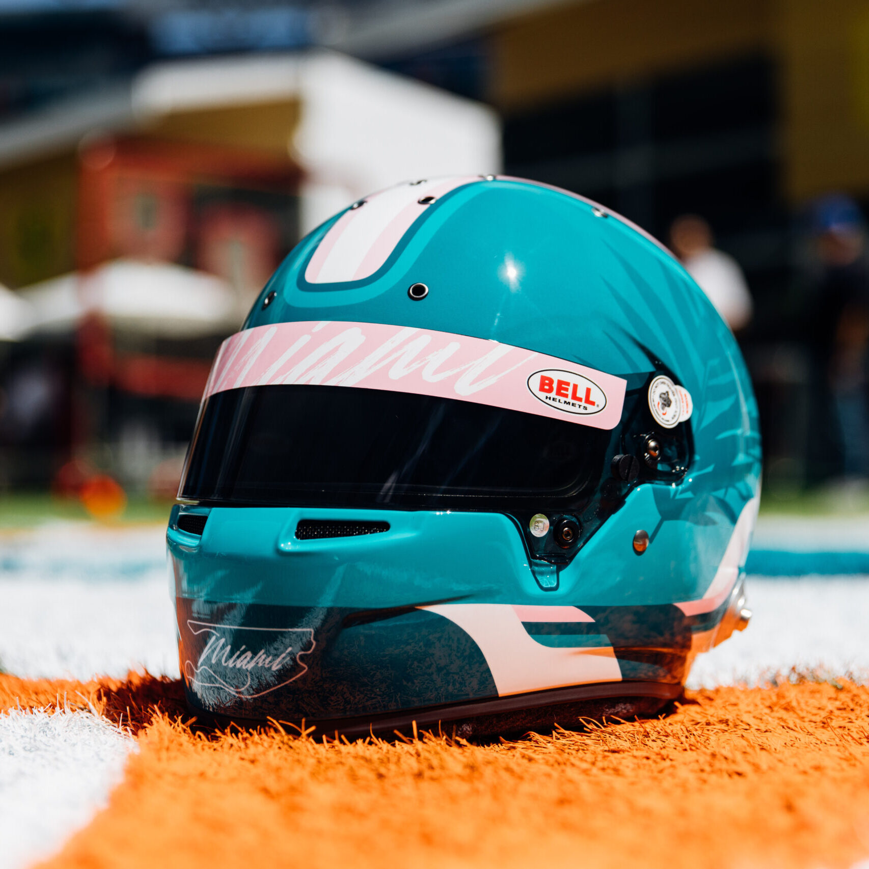Full size bell racing helmet in colors aqua and black with a black visore